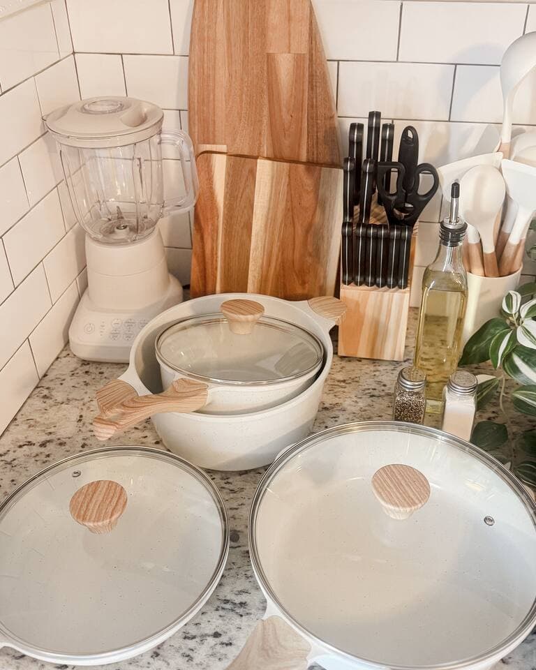 Kitchen essentials; silverware, a knife set with block, pots, pans, baking sheets, olive oil, salt and pepper